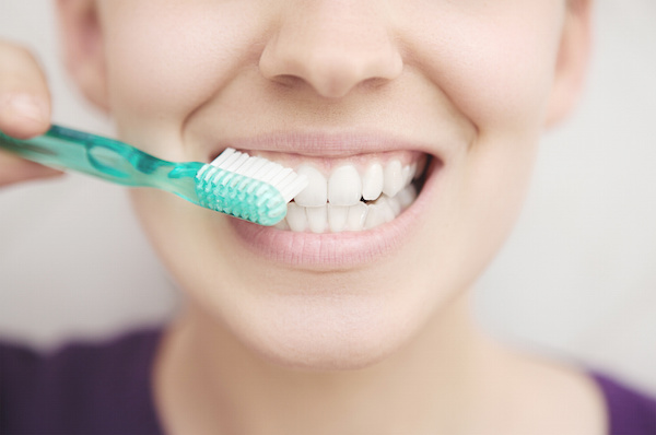 What causes receding gums?